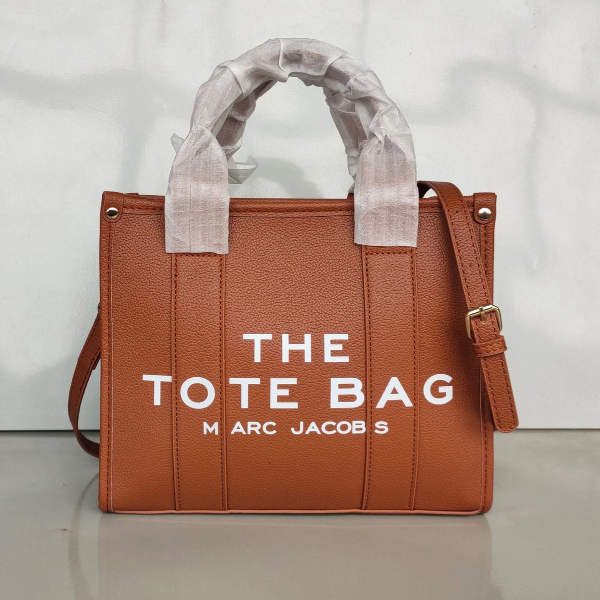Women's Crossbody Tote Bag – Embossed Details, Compact Design — Three line characters - brown